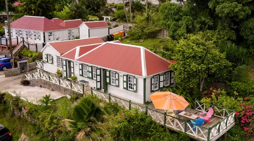 Saba Island house with a red roof and garden.